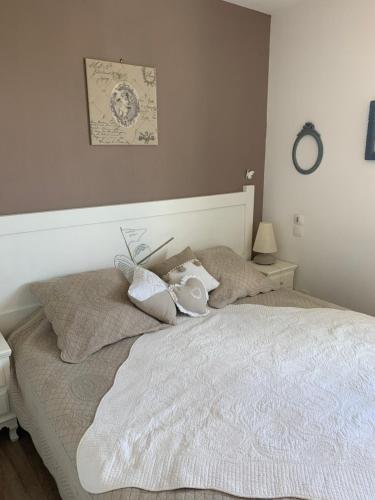 a bedroom with a white bed with pillows on it at domaine du green castelgreen in Rivières
