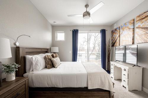 a bedroom with a large bed and a window at Contemporary Zen Townhome with a View - Wash Park in Denver