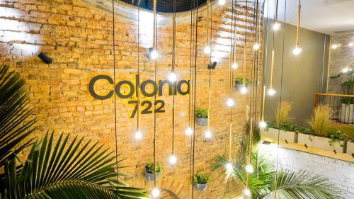 a brick wall with a sign that says colombo on it at 201 Aparta Studio Boutique en mansión siglo XIX in Bogotá