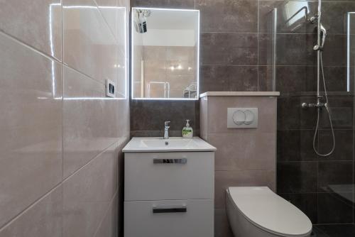 a bathroom with a toilet and a sink and a shower at Apartment Leo in Trogir