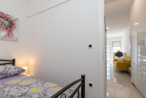 a bedroom with a bed and a hallway at Apartment Leo in Trogir