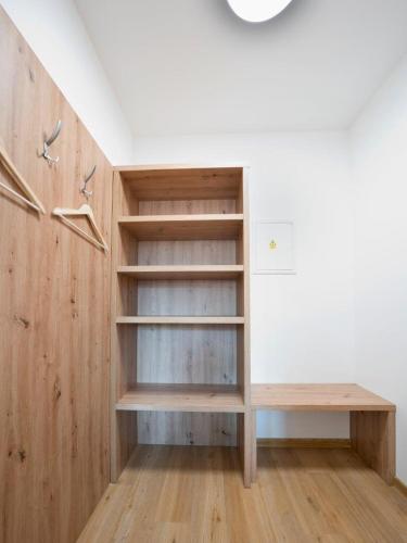 a room with wooden shelves and a wall at Penzion SALAŠ in Salaš