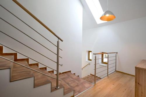 a staircase in a home with wooden floors and a ceiling at Penzion SALAŠ in Salaš