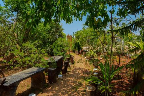 a row of benches sitting on a dirt trail at Sunntop Cabana in Trincomalee
