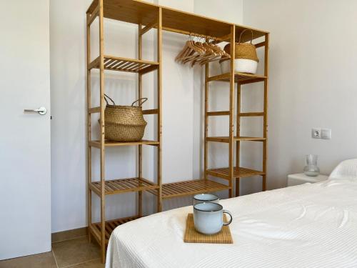 a room with wooden shelves next to a bed at Lancón Boutique Carboneras in Carboneras