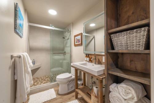 a bathroom with a sink and a toilet and a shower at Northstar Bike Hike Ski In and Out Condo Pools Hot Tubs Courts Walk to Village in Truckee