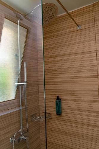a shower with a glass door in a bathroom at Olympion Village in Kavos