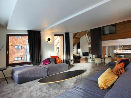 a living room with two couches and a table at Chalet Avoriaz, 6 pièces, 12 personnes - FR-1-314-192 in Avoriaz