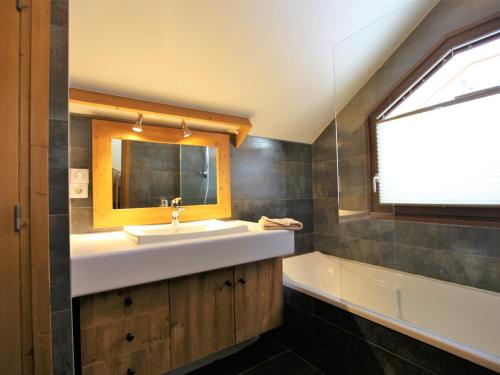 a bathroom with a sink and a mirror and a tub at Chalet Avoriaz, 6 pièces, 12 personnes - FR-1-314-192 in Avoriaz