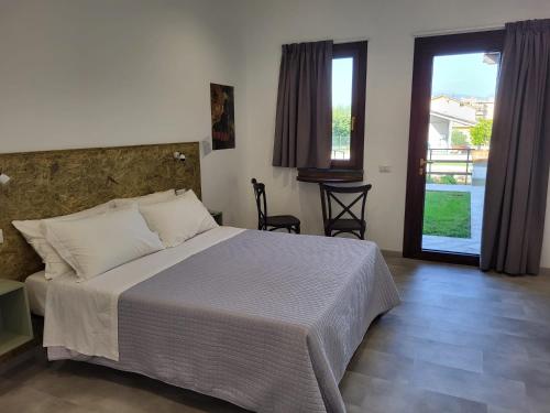 a bedroom with a bed and a door to a balcony at Casa MaLa’ in Ceprano