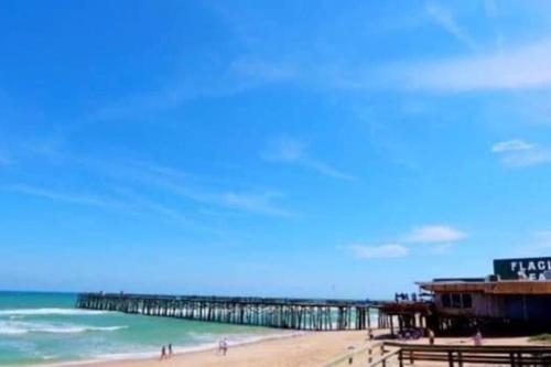 a view of a beach with a pier and the ocean at Perfect Getaway in Palm Coast