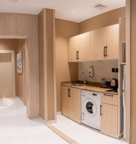 a laundry room with a washer and dryer at Mostagr Serviced Apartments - Yasmine in Hail