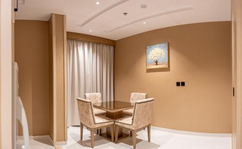 a dining room with a table and chairs at Mostagr Serviced Apartments - Yasmine in Hail