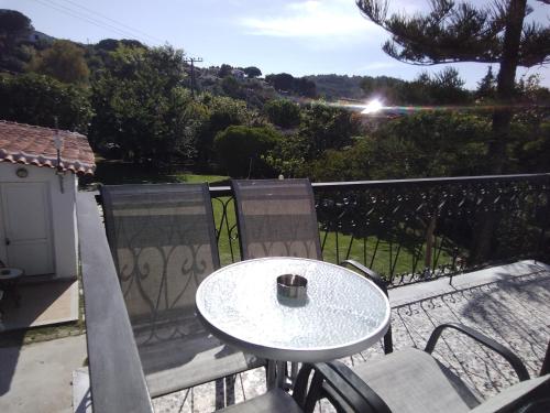 a table and chairs on a balcony with a view at Villa Ourania in Troulos
