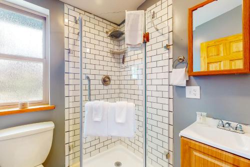 a bathroom with a shower and a toilet and a sink at West Side Cottage in Boise