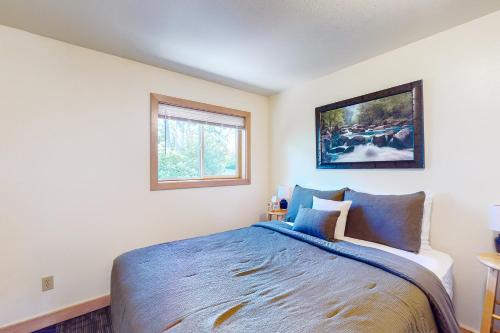 a bedroom with a blue bed with a picture on the wall at Beachcombers Hideaway in Florence