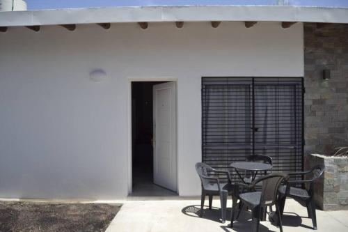 a patio with a table and chairs next to a building at Almirante Brown 235 , Dpto 5 in San Martín