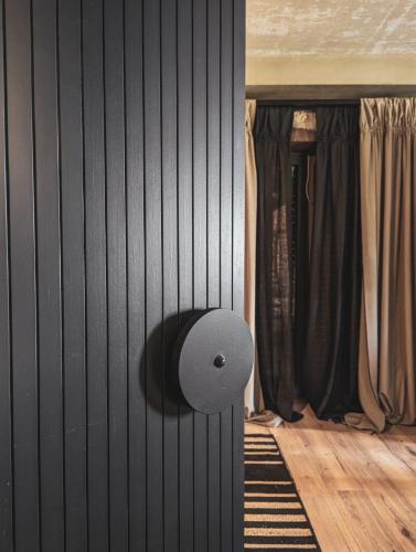 a room with a black wall with a door at Three Dots Boutique Suites in Soúlion