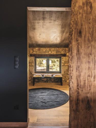 a room with a bench in a room with a window at Three Dots Boutique Suites in Soúlion
