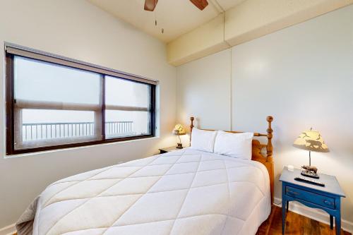 a bedroom with a large bed and a window at Grandfather View in Sugar Mountain