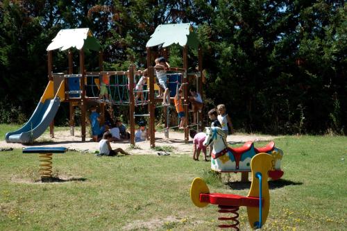 a group of children playing on a playground at Green Village Assisi in Assisi