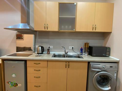 a kitchen with a sink and a washing machine at Studio apartment in Yerevan in Yerevan