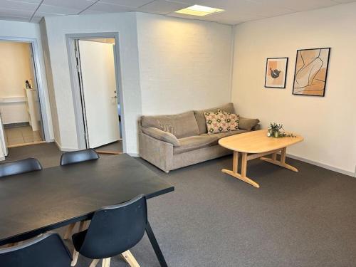 a living room with a couch and a table at City 6-bedroom gammel in Aalborg