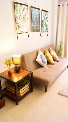 a living room with a couch and a table at Manila Airport Staycation near NAIA Terminal 3 in Manila