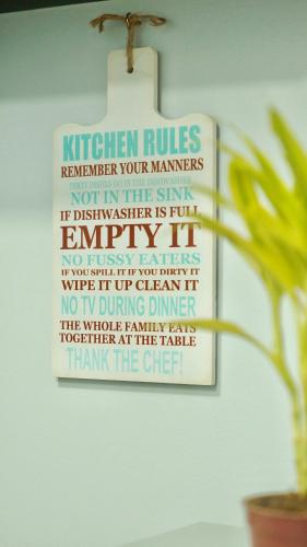 a sign that reads kitchen rules remember your manners at Manila Airport Staycation near NAIA Terminal 3 in Manila