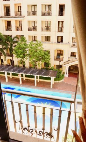 a view from a balcony of a building with a pool at Manila Airport Staycation near NAIA Terminal 3 in Manila