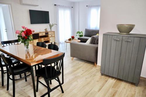 a living room with a table and a couch at GK - Modern Apartment in Nafpaktos