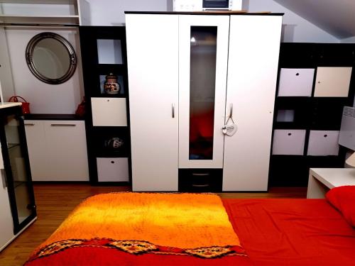 a bedroom with white cabinets and a mirror at Apartment - MY DESTINATION in Slavonski Brod