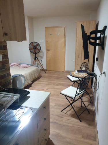 a room with a bed and a table and chairs at Apartma Rešer in Črna na Koroškem