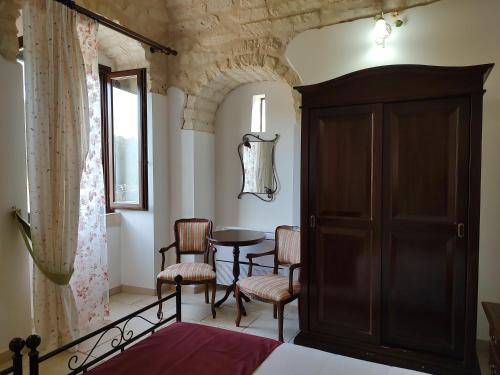 a bedroom with a table and chairs and a bed at Torre Bruno in Carpino