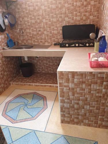 a kitchen with a counter with a laptop on it at Dar rachid ouzoud in Azilal