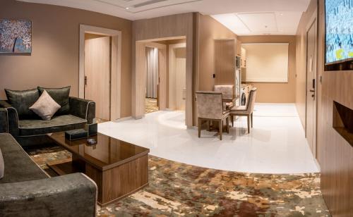 a living room with a couch and a table at Mostagr Serviced Apartments - Yasmine in Hail