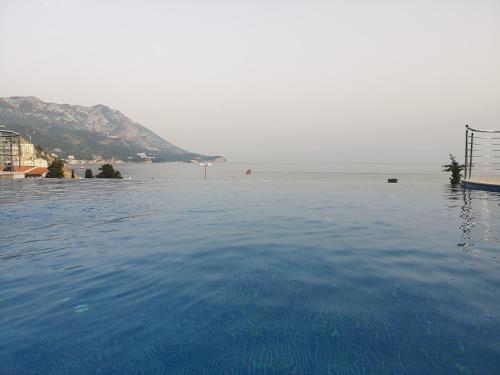 a swimming pool with a view of the ocean at Beach Pearl in Bečići