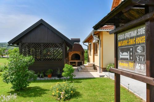 a building with a sign in front of it at House Matijević Šimić in Grabovac