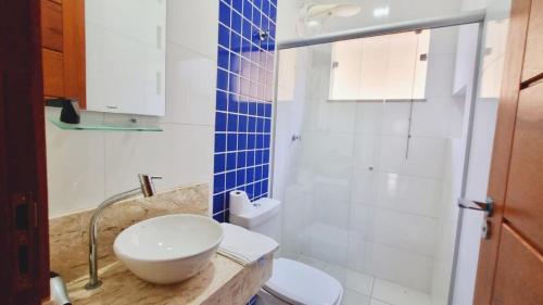 y baño con aseo blanco y lavamanos. en Residencial Recanto da Lagoa - Praia de Taperapuan, en Porto Seguro