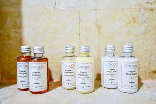 a group of four bottles of sauce on a counter at OP downtown Studio by Casago in Playa del Carmen