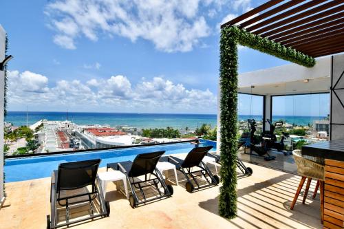 a balcony with a view of the ocean at OP downtown Studio by Casago in Playa del Carmen
