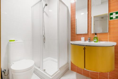 a bathroom with a shower and a toilet and a sink at Caparica Beach Charming in Costa da Caparica