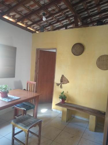um quarto com uma mesa e uma mesa e cadeiras de madeira em Chácara lua e Sol em Pouso Alegre
