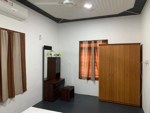 a room with a wooden cabinet and a window at Nesan’s villa in Trincomalee