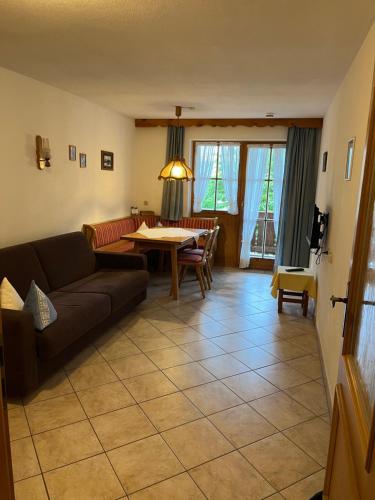 a living room with a couch and a table at Beim Hanslbauer in Reit im Winkl