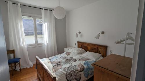 阿爾熱萊斯加佐斯特的住宿－Villa d'Azun，一间卧室配有一张床、一张书桌和一个窗户。