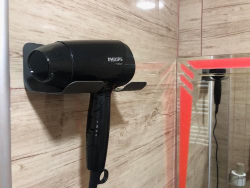 a hair dryer is attached to a wall at Elizabeth's Rooms in Kutaisi