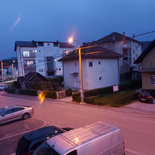 a street with cars parked on a street with buildings at Tijana 2 in Pale