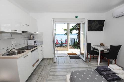 a kitchen and dining room with a view of the ocean at Bellevue Molet apartments Koper in Koper