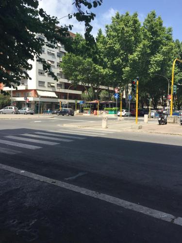an empty street with a traffic light in a city at De Guestibus in Rome